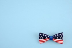 Bow tie with the image of the US flag on a blue background.The symbol of the United States.For the design of postcards,banners in clothing,accessories stores for national holidays.Independence Day
