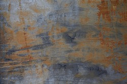 Dark textured painted cracked multicoloured rusty aged metal background.