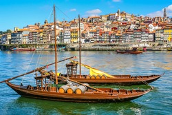 Cityscape of the city of Porto, Douro river with its old boat and its typical colored houses on the water's edge. Portugal. Europe.