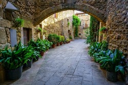 Passageways with stone arcade and medieval houses in a picturesque style and of great beauty, Monells, Girona, Catalonia