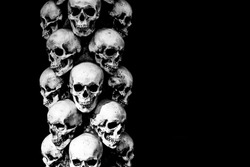 Gloomy skulls on a dark background. Skulls stand on top of each other.