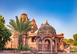 ancient hindu temple architecture with bright blue sky from unique angle at day shot taken at mandore garden jodhpur rajasthan india.
