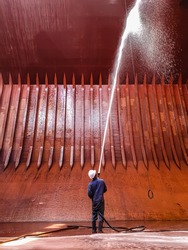 ship crews are performing cargo hold cleaning on a bulk carrier. preparing for loading cargo.