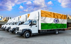 India flag on the back of Five new white trucks against the backdrop of the river and the city. Truck, transport, freight transport. Freight and Logistics Concept