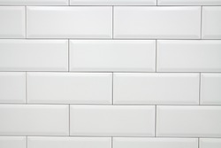 Ceramic decorative tiles of simple texture covering walls of kitchen, bathroom or toilet, old vintage style and white color