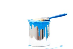 open, painted bucket and paintbrush on a white backdrop.