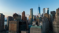 A high angle, aerial view of lower Manhattan, NY on a beautiful evening just before sunset. The drone camera is looking north towards the Freedom Tower.