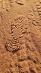 Australian made shoe footprint in the red dirt at Uluru