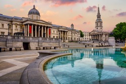 The Trafalgar square in London, England, with National Gallery and St Marting on the Fields church in dramatic light