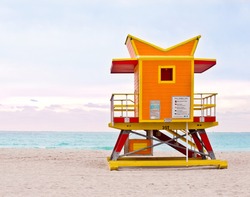 Orange lifeguard tower, art deco Miami Beach life guard stand on South Beach at sunrise
