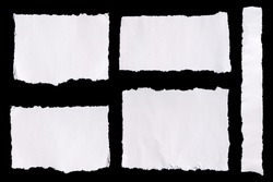 Collection of white ripped pieces of paper on black background