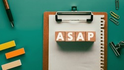 There is wood cube with the word ASAP. It is an abbreviation for As soon as possible as eye-catching image.