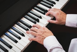 Closeup hand man playing piano. Classical music instrument. Fade color tone.