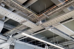 electric networks, cable trays, low-voltage networks of different colors on the ceiling