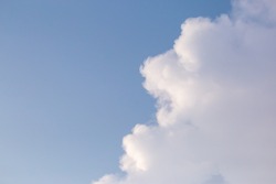 Soft white clouds in the close-up sky look dense, beautiful for background design, copy space available. Blue background