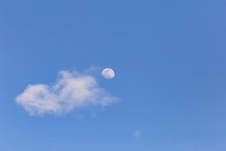 moon with white clouds blue background The afternoon moon has space for messages.