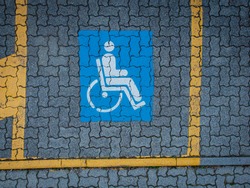 Car parking lot which is reserved for person with wheelchair logo marking on tile floor