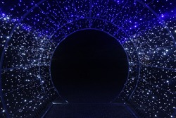 tunnel and illuminations of blue white on a black dark background. New Year's Eve Christmas. Photoona festive atmosphere.