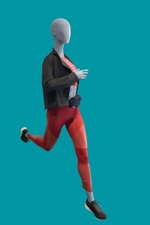 Full length image of a running female display mannequin wearing sportswear isolated on a green background