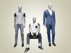 Three male mannequins dressed in casual clothes over yellow background. No brand names or copyright objects.