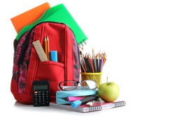 red school backpack with school supplies  on a white isolated background