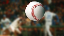 Baseball ball on blurred crowd background. Sport competitions.