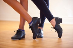 Image of tap shoes from a tap dance class in a dance studio.