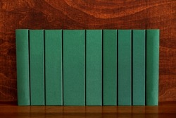 Green antique book volumes in row. Blank hardback book spine. Old books banner.