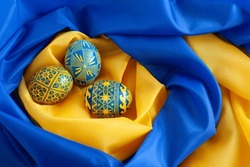 blue and yellow Easter eggs on the background of the flag of Ukraine
