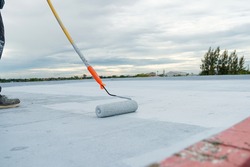 Hand painted gray flooring with paint rollers for waterproof, reinforcing net,Repairing waterproofing deck flooring. roof, floor.