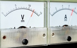 Arrow of the analog DC voltmeter shows the value of 12 volts.                 