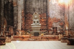 Ancient Buddha statue in an old temple in Lopburi province, Thailand.                           