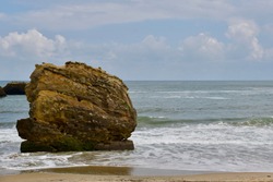 Giant rock in the sea. Landscape of a beach with waves breaking on a big rock. Biarritz french Basque Country in southwestern France.