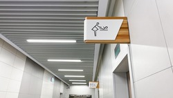 Public toilet sign for restroom. Baby changing facilities and feeding area. Men, women and disabled lavatory  on blurred background