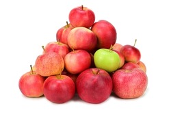 A pile of red and yellow apples. Among them is one green apple. Isolated on white background. Light shadow at the bottom.