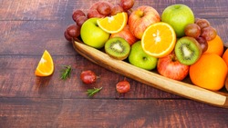 close up colorful fresh fruit orange apple grape kiwi fruit full of vitamin c on wooden table