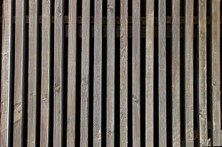 background of vertical old wooden battens with dark spaces                               