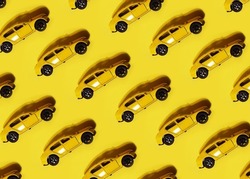 Kid toy cartoon miniature yellow car model playful isometric seamless pattern wallpaper. Minimal auto repair shop or vehicle transport insurance concept background banner. Flat lay.