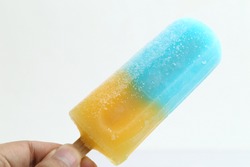 Fruit ice cream on a stick. Bright color, summer mood.