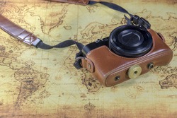 dirty pocket compact camera on a old world map