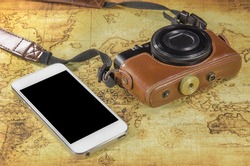 smartphone and pocket camera on a world map