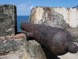 Old cannon pointing out to sea at El Morro Fort, Old San Juan, Puerto Rico
