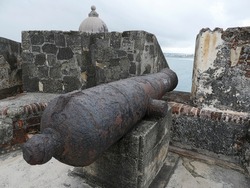 Windows barred by strong iron grills at the back part of El Morro Fort, facing the sea at Old San Juan, Puerto Rico