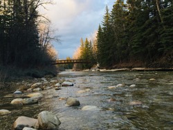 A shot of a bridge in Fish Creek, taken from the middle of the creek. Taken at sunset on a cold spring evening. 
