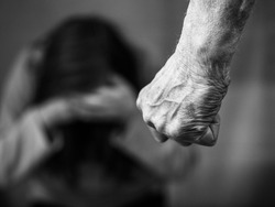 Domestic violence man against woman clenched fist black and white image