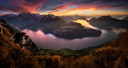 Panorama of Vierwaldstattersee and mountains in autumn during vibrant and colorful sunset. 