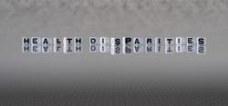 health disparities concept represented by black and white letter cubes on a grey horizon background stretching to infinity