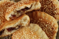 Date filled pastry with sesame, close up on pastry with sesame known as ‘kombe’ in Hatay, Turkey.