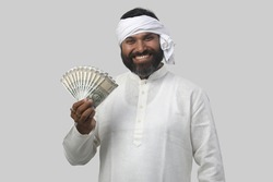 Indian farmer  with currency notes,   on a white background. 