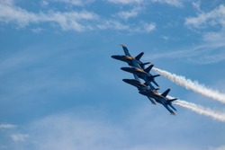 Navy Blue Angels formation with smoke